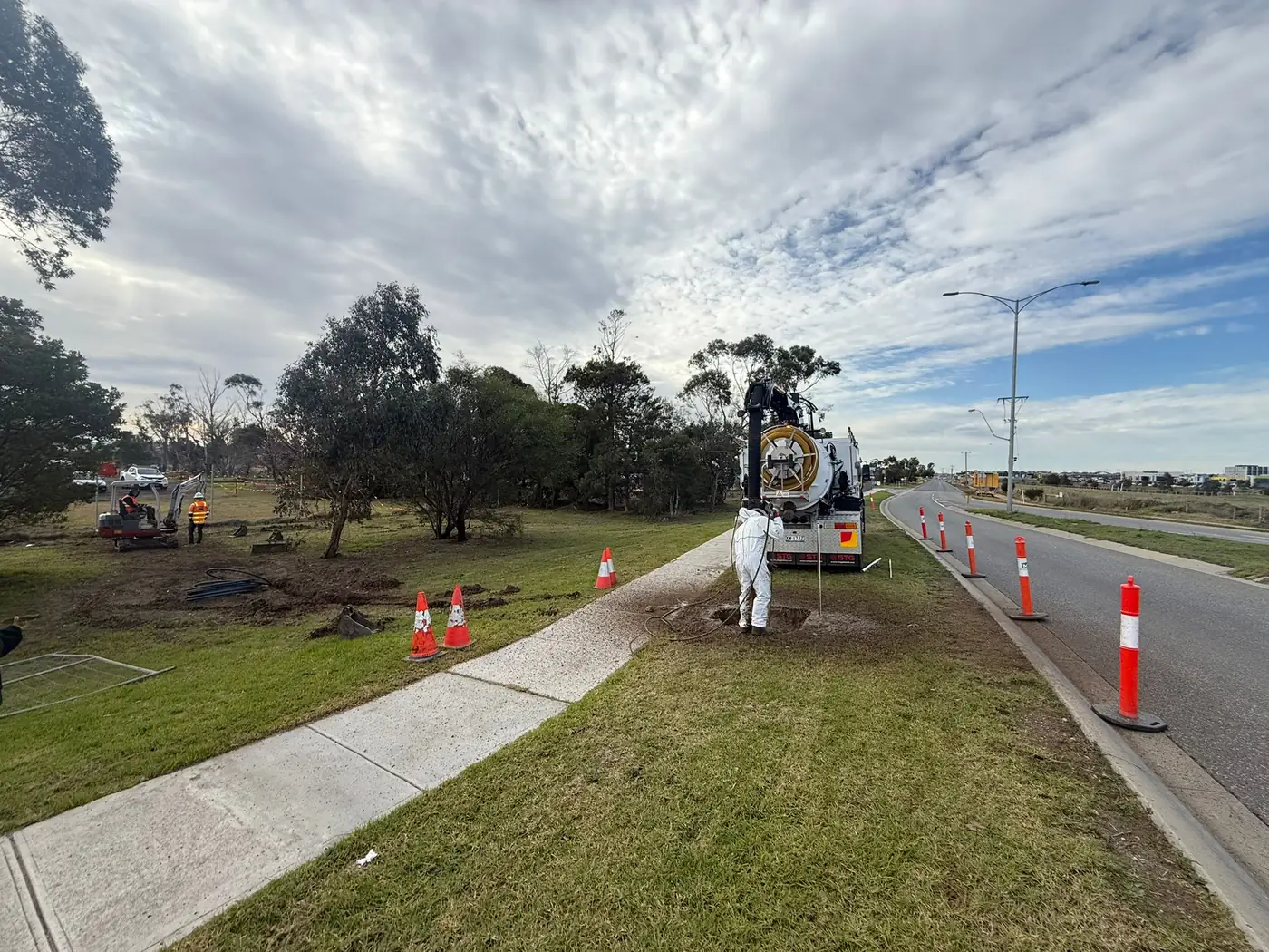 Hydro excavation on a nature strip with traffic cones set out